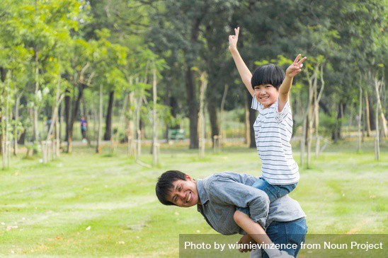 Boy raising arms up in the air on his father’s back by winnievinzence from Noun Project