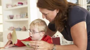 A small child with glasses getting Early Intervention services.