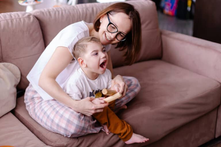 mother & son playing together on the couch