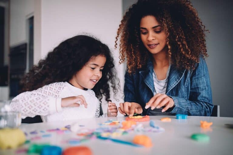 Young girl and woman engaging in a creative activity together.